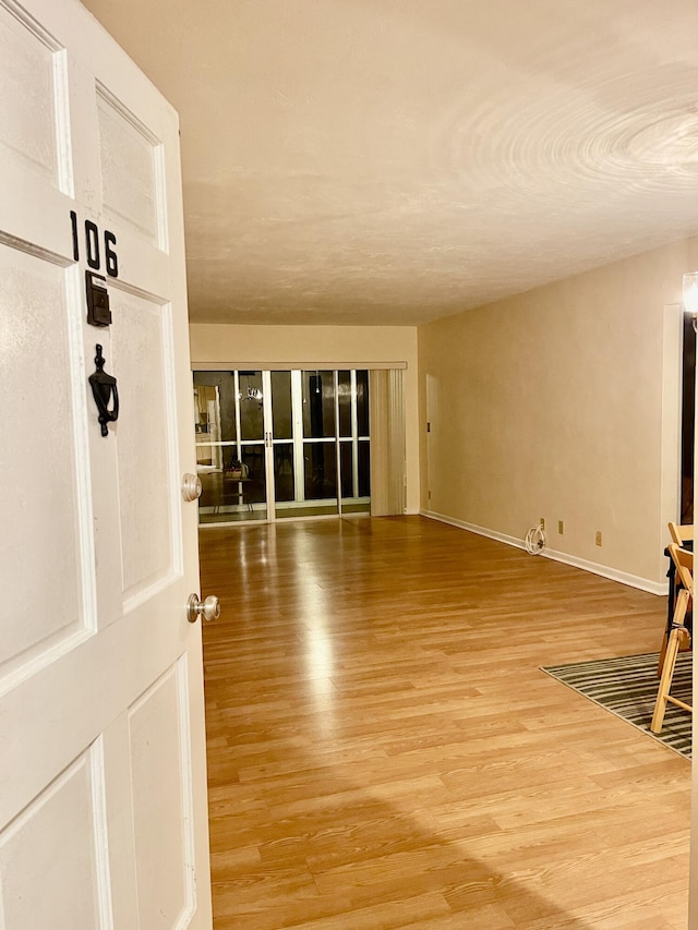 unfurnished room with wood-type flooring