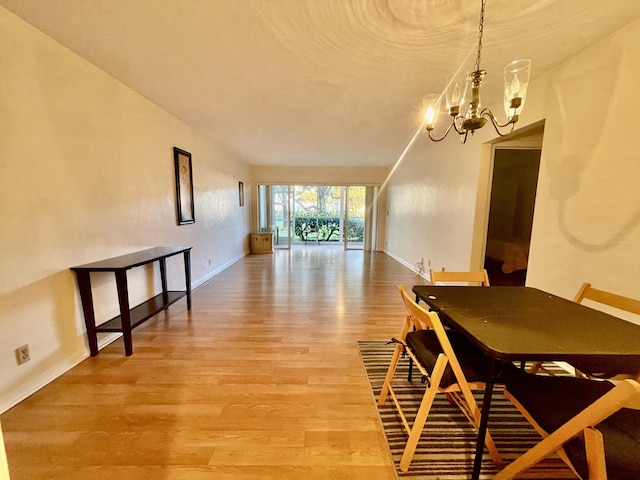 dining room featuring wood-type flooring and a notable chandelier