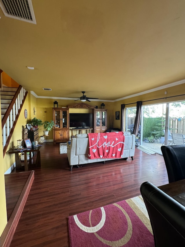 living room featuring crown molding, ceiling fan, and dark hardwood / wood-style flooring