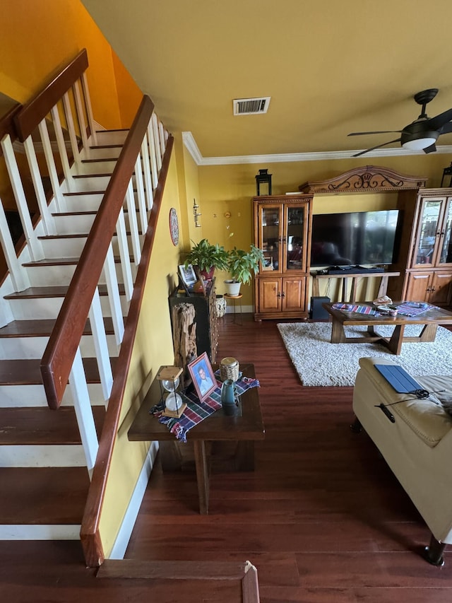 living room with crown molding, dark hardwood / wood-style floors, and ceiling fan