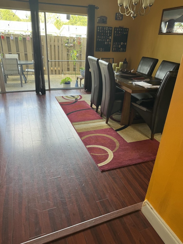 dining space featuring hardwood / wood-style floors and a notable chandelier