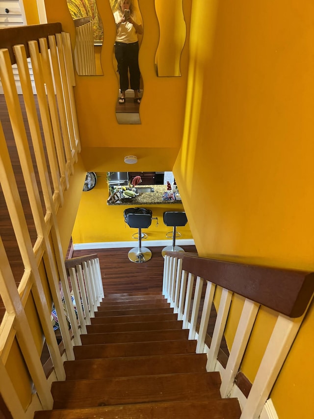 stairway with hardwood / wood-style floors