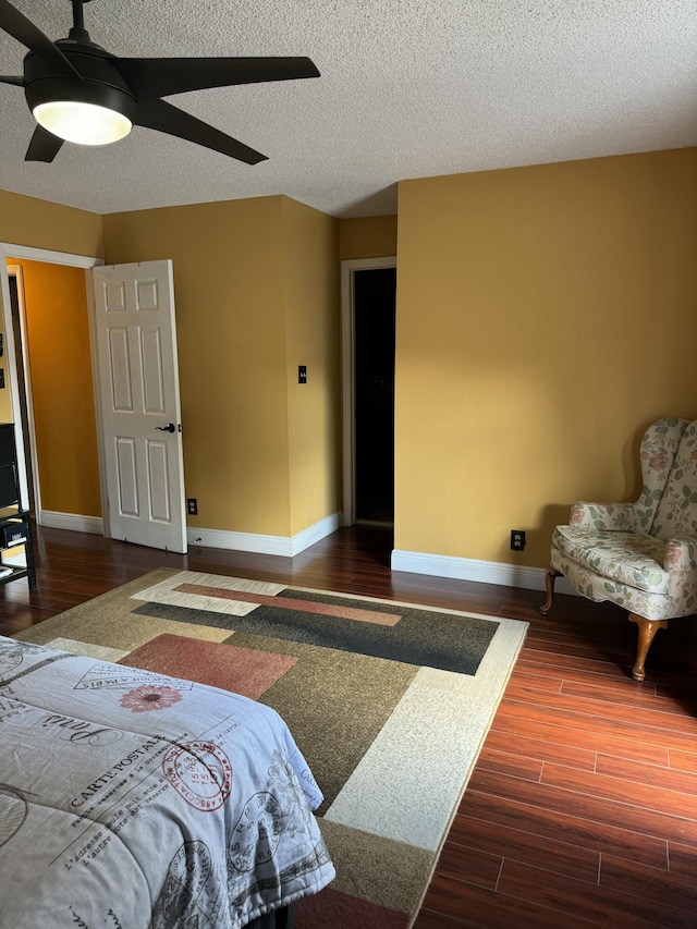 bedroom featuring wood-type flooring, ceiling fan, and a textured ceiling