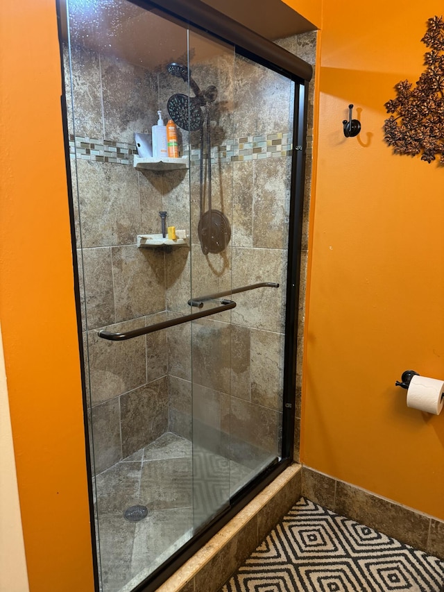 bathroom with tile patterned flooring and an enclosed shower