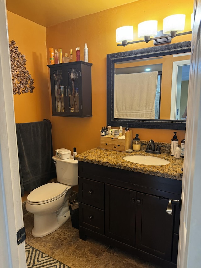 bathroom with vanity, toilet, and tile patterned flooring