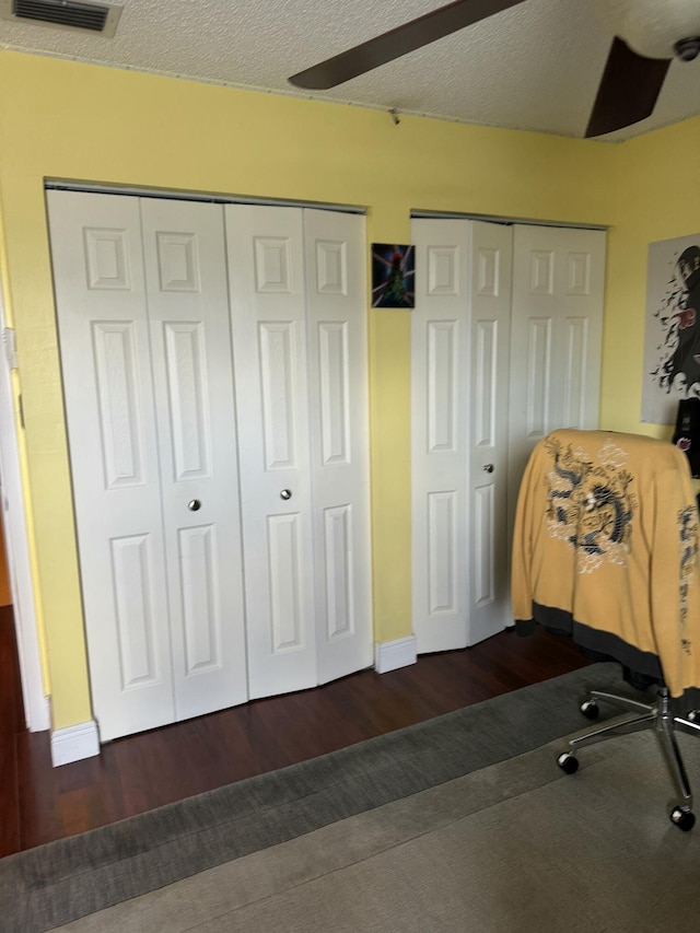 office featuring dark wood-type flooring and a textured ceiling