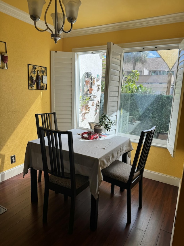 dining area with a wealth of natural light, dark hardwood / wood-style floors, and a chandelier