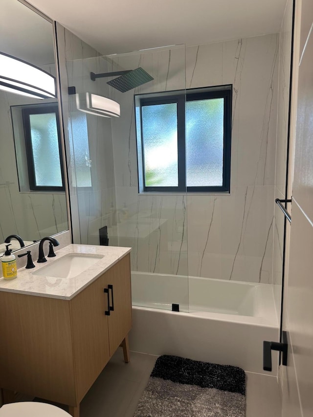 full bathroom with vanity, toilet, and tiled shower / bath combo