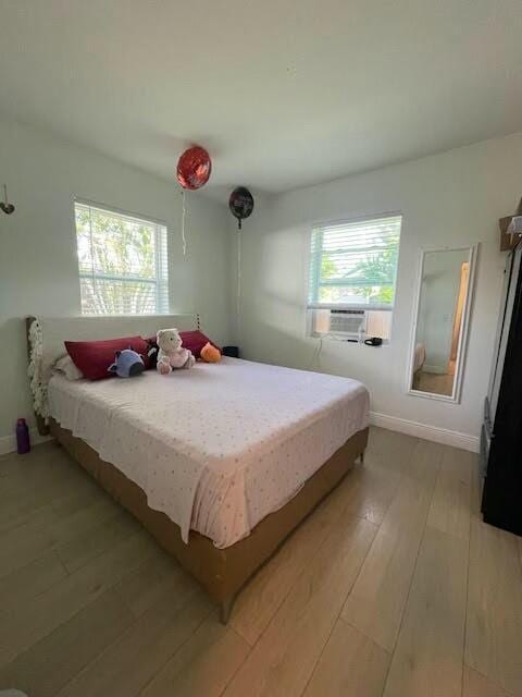 bedroom featuring cooling unit and light hardwood / wood-style flooring