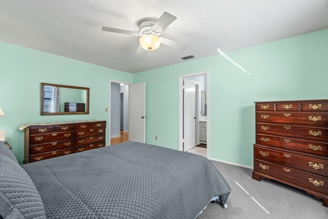 carpeted bedroom featuring connected bathroom and ceiling fan