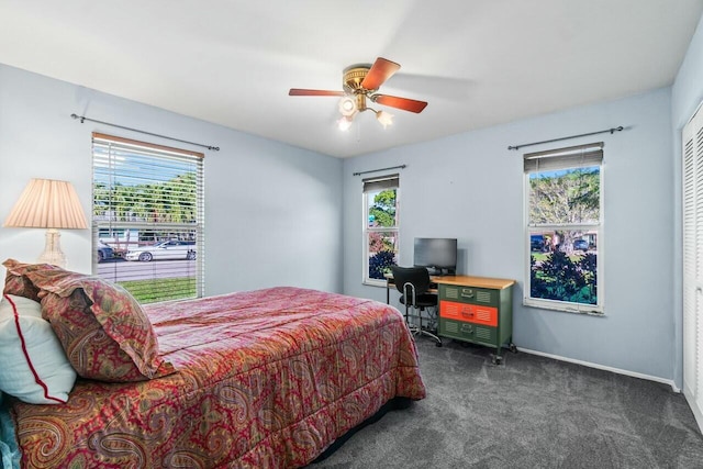 carpeted bedroom featuring ceiling fan and multiple windows