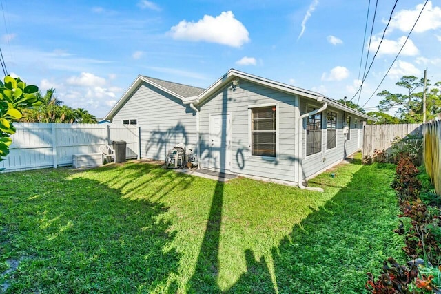 rear view of house with a yard