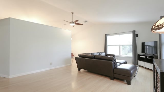 living room featuring vaulted ceiling, light hardwood / wood-style floors, and ceiling fan