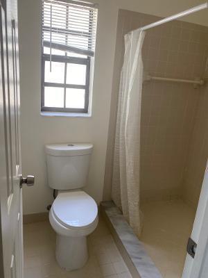 bathroom featuring toilet and walk in shower