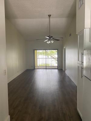 unfurnished room with high vaulted ceiling, a textured ceiling, ceiling fan, and dark hardwood / wood-style floors