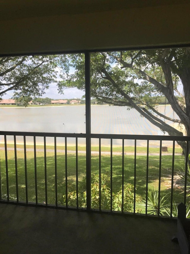 unfurnished sunroom with a water view and a wealth of natural light