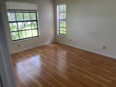 spare room with a healthy amount of sunlight and dark hardwood / wood-style floors