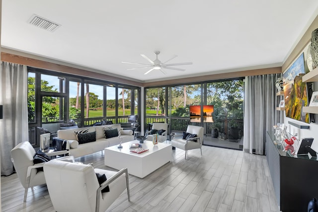 living room with ceiling fan and light wood-type flooring