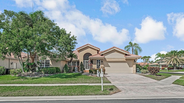 mediterranean / spanish-style house with a front lawn and a garage