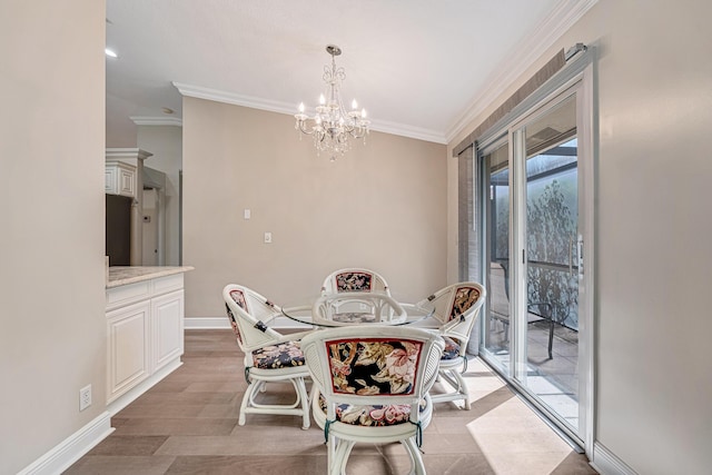 dining area with an inviting chandelier, light hardwood / wood-style flooring, and crown molding