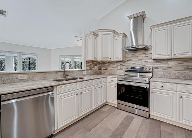 kitchen with stainless steel appliances, sink, ornamental molding, tasteful backsplash, and wall chimney exhaust hood