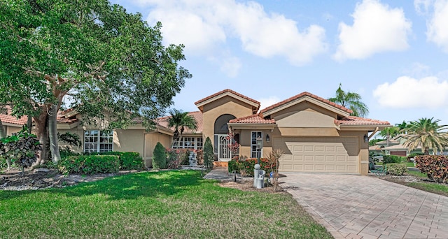 mediterranean / spanish house with a front yard and a garage