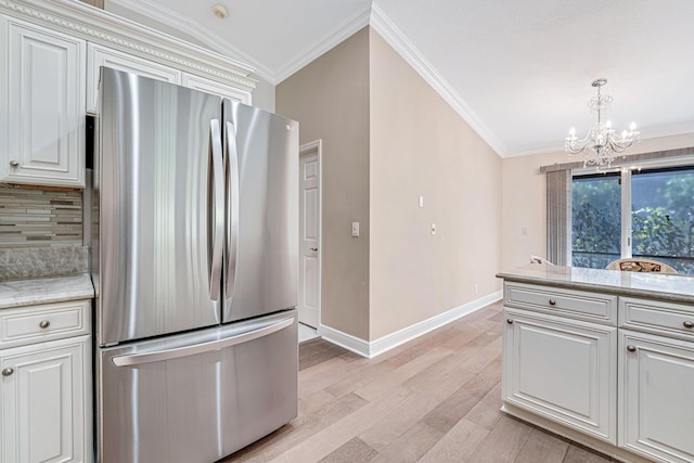 kitchen with stainless steel refrigerator, light hardwood / wood-style floors, white cabinetry, and crown molding