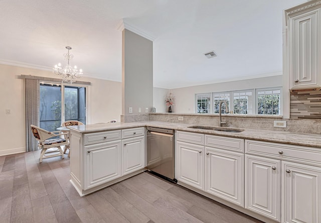 kitchen featuring sink, decorative light fixtures, stainless steel dishwasher, kitchen peninsula, and white cabinets