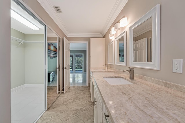 bathroom with ornamental molding and vanity