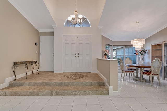 tiled foyer entrance with ornamental molding, a chandelier, and vaulted ceiling