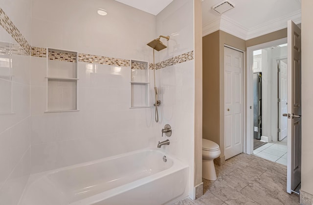 bathroom with tiled shower / bath combo, crown molding, and toilet