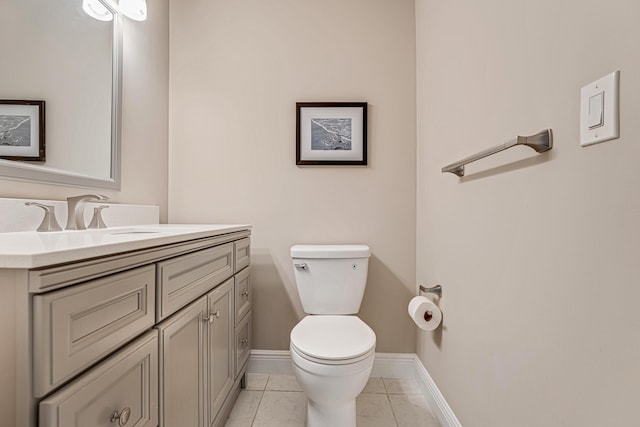 bathroom with vanity, toilet, and tile patterned floors