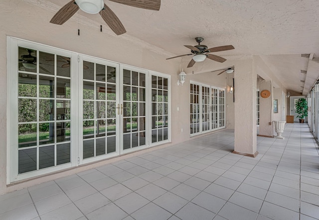 view of patio with french doors and ceiling fan