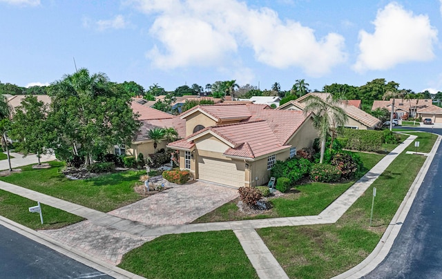 mediterranean / spanish-style house with a garage and a front yard