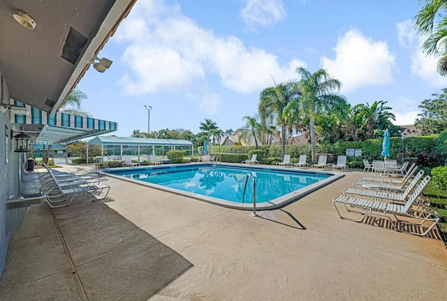 view of swimming pool with central AC and a patio area