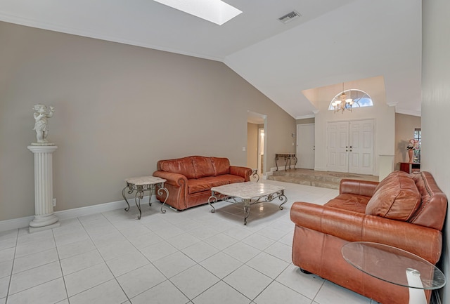 tiled living room featuring vaulted ceiling with skylight, an inviting chandelier, and decorative columns