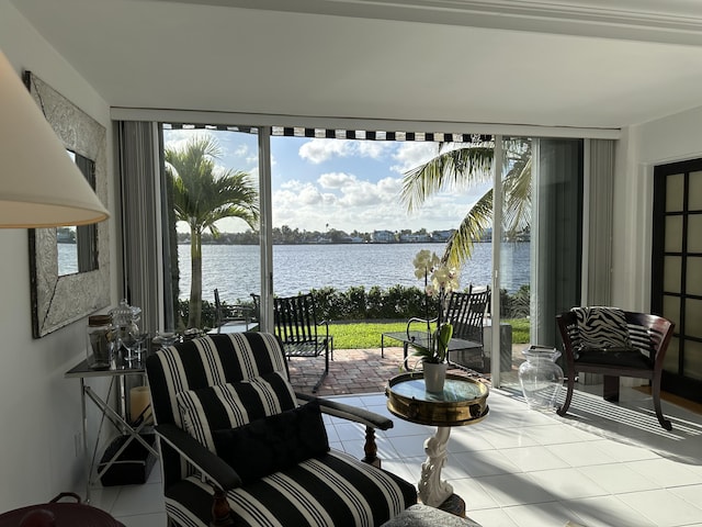 sunroom featuring a water view and a patio area