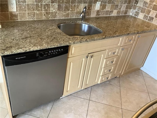 kitchen with sink, light tile patterned floors, dishwasher, light stone countertops, and backsplash