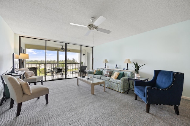 living room featuring ceiling fan, floor to ceiling windows, carpet, and a textured ceiling