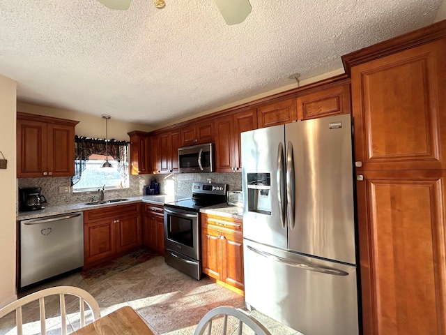 kitchen with stainless steel appliances, sink, light stone counters, and decorative backsplash