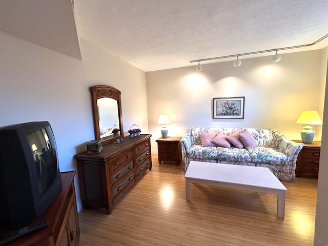 bedroom featuring light hardwood / wood-style flooring and a textured ceiling