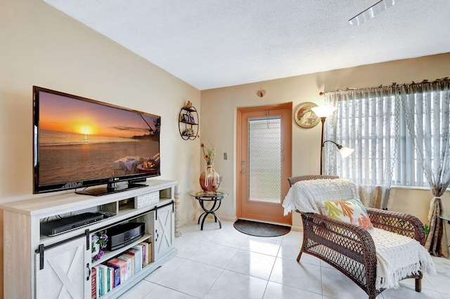 living room featuring light tile patterned floors and a textured ceiling