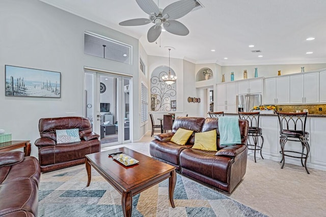 living room featuring ceiling fan with notable chandelier and vaulted ceiling