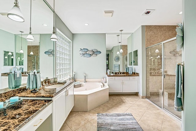 bathroom featuring vanity, plus walk in shower, and tile patterned flooring