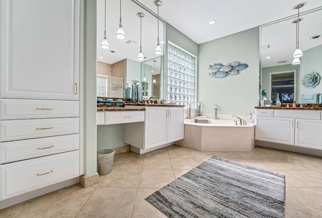 bathroom featuring vanity, independent shower and bath, and tile patterned flooring