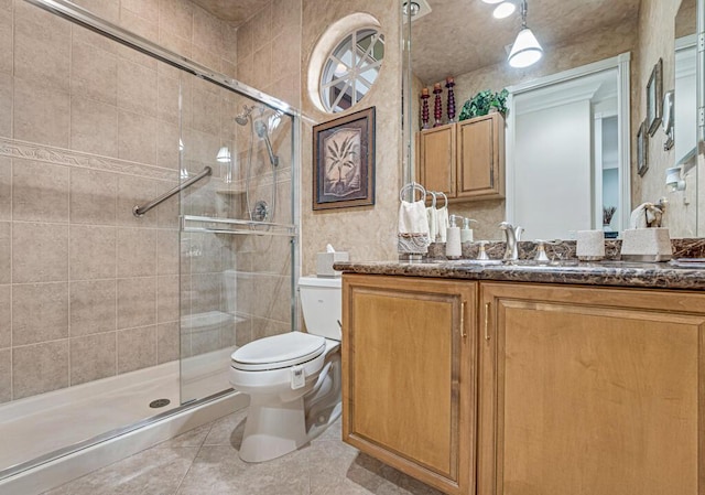 bathroom featuring vanity, an enclosed shower, tile patterned floors, and toilet