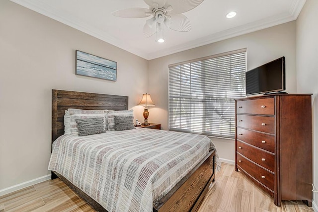 bedroom featuring crown molding, light hardwood / wood-style flooring, and ceiling fan