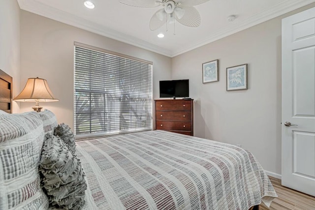 bedroom with ceiling fan, ornamental molding, and light hardwood / wood-style flooring