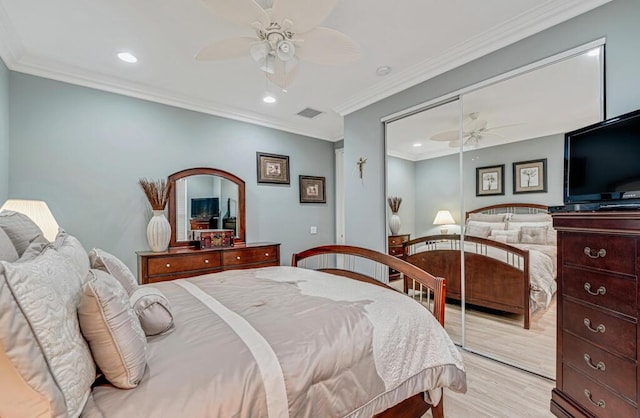 bedroom with crown molding, ceiling fan, and light hardwood / wood-style floors