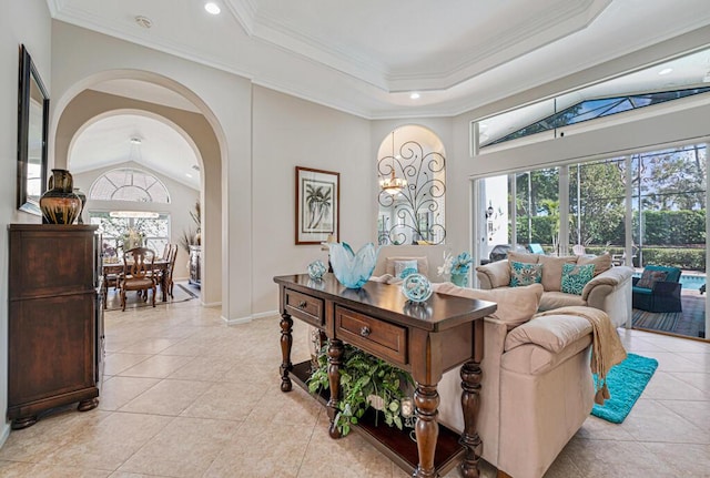 tiled living room featuring crown molding, a tray ceiling, and lofted ceiling